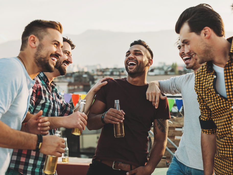 Männer lachen und trinken Bier