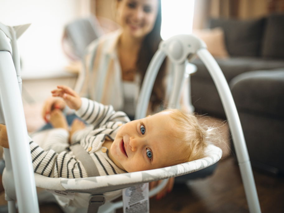 Lachendes Baby in der Wippe.