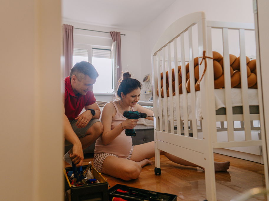Schwangere bereitet Babybett vor