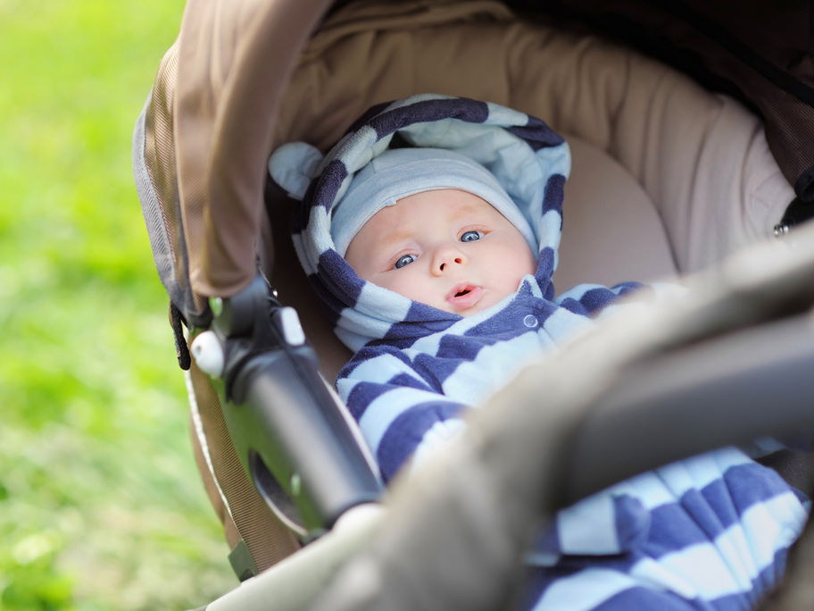 Baby liegt im Kinderwagen