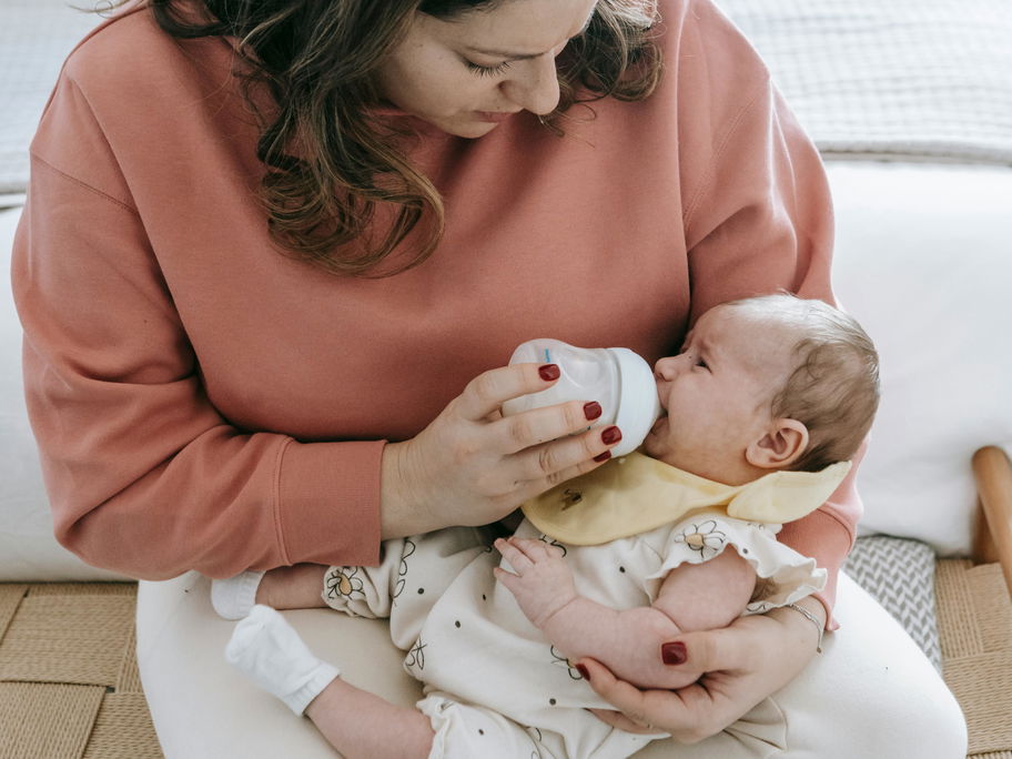 Ein Baby wird mit Flasche gefüttert.