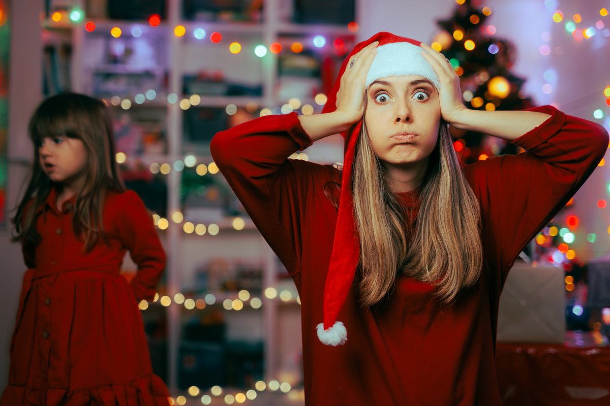 Mutter schlägt an Weihnachten die Hände über dem Kopf zusammen.