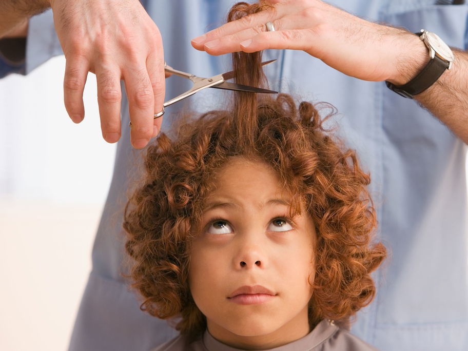 Einem Kind werden die Haare geschnitten.